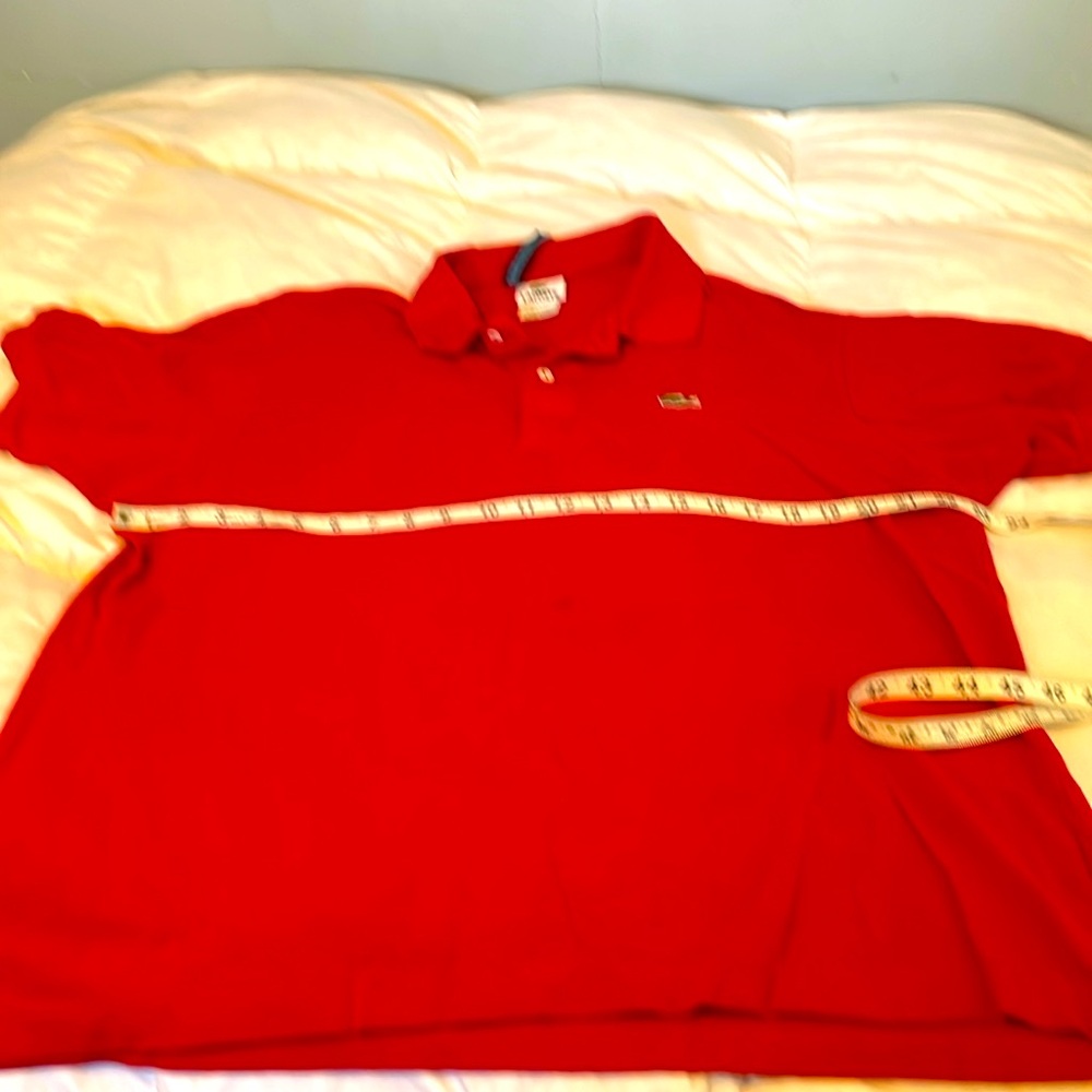 Bright red Lacoste. Size 7. Translates to a small or medium men’s